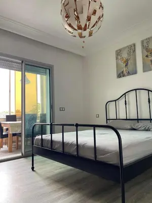 a bedroom with a bed and a chandelier at La siesta beach resort in Oulad Akkou