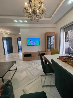a living room with a chandelier and a table at La siesta beach resort in Oulad Akkou