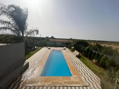 an overhead view of a swimming pool in a house at Maison au calme avec piscine privé et arboré in Meknès