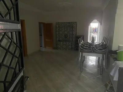 a room with a table and chairs and a door at Maison au calme avec piscine privé et arboré in Meknès