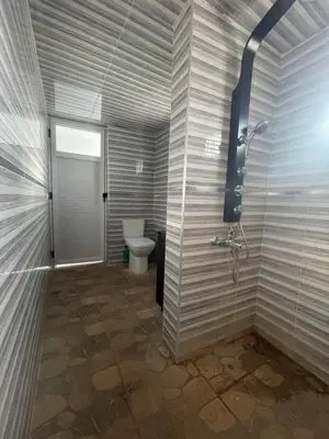 a bathroom with a toilet and a shower at Maison au calme avec piscine privé et arboré in Meknès