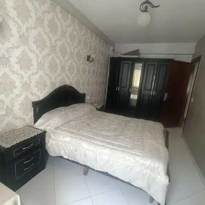 a bedroom with a bed and a dresser in it at Res zin el mahabba in Oulad Akkou