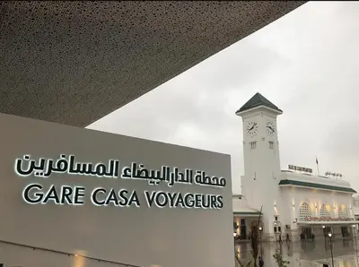 a building with a clock tower in front of it at Res zin el mahabba in Oulad Akkou