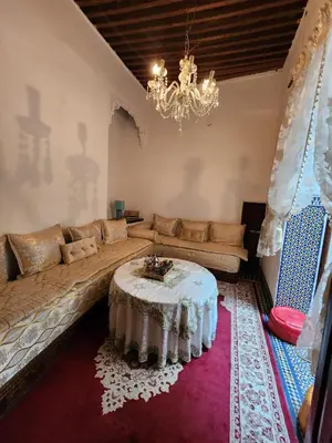 a living room with a couch and a table at Riad Bennouna in Fès