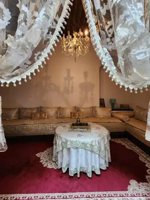 a living room with a couch and a table at Riad Bennouna in Fès