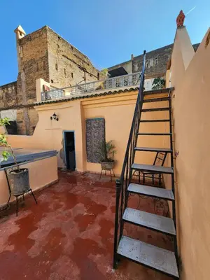 a staircase in the courtyard of a building at Riad Bennouna in Fès