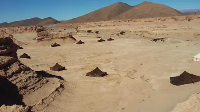 an aerial view of a desert with huts and mountains at Campement Akka Nait Sidi - Tissint in Tissint