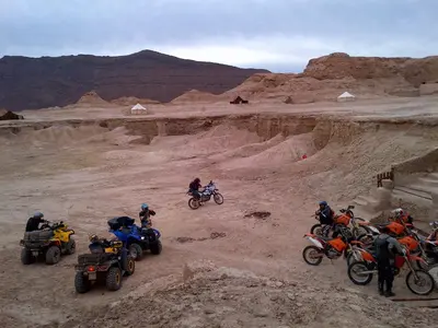 a group of people riding motorcycles in the desert at Campement Akka Nait Sidi - Tissint in Tissint