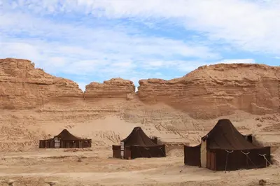 a group of tents in the desert with rocks at Campement Akka Nait Sidi - Tissint in Tissint