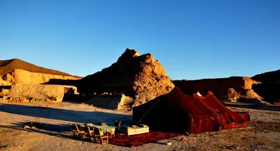 a group of chairs and a tent in the desert at Campement Akka Nait Sidi - Tissint in Tissint