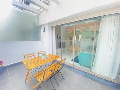 a dining room with a table and chairs and a pool at Superbe appart central in Oulad Akkou