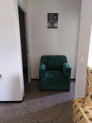 a green chair sitting in a corner of a room at 2bedroom Apartments in Downtown in Fès