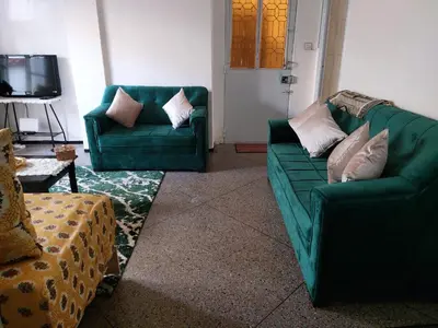 a living room with two green couches and a television at 2bedroom Apartments in Downtown in Fès