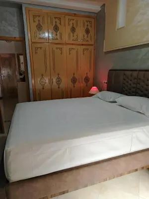 a large white bed in a room with at Appartement Confortable à Louer in Oulad Akkou