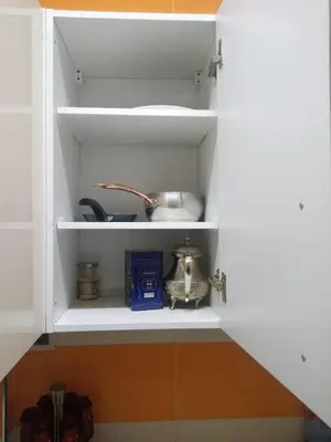 a kitchen pantry with white cabinets and a shelf at Appartement Confortable à Louer in Oulad Akkou
