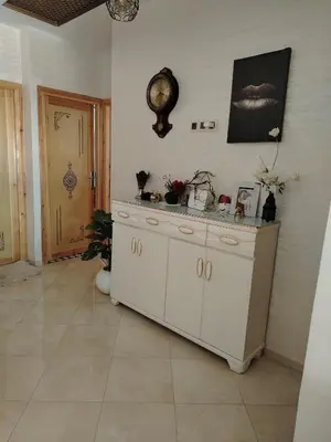 a white cabinet in a room with a wall at Appartement Confortable à Louer in Oulad Akkou