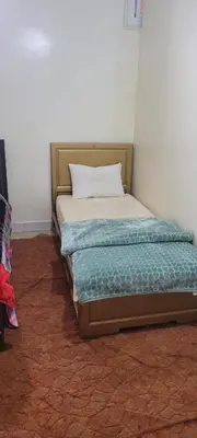 a bed with a pillow on it in a room at faouzi walid in Er Rachidia