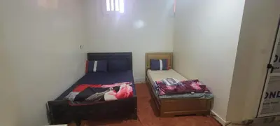 two beds in a small room at faouzi walid in Er Rachidia