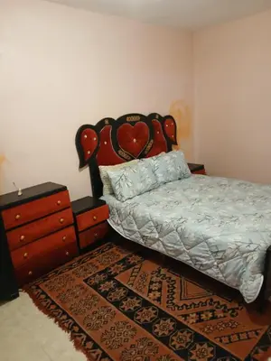 a bedroom with a bed and a dresser at house Merinides fes in Fès