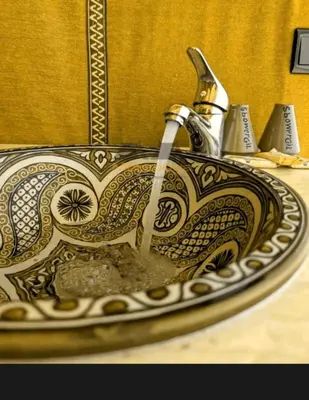 a sink with a faucet in a bathroom at One Thousand and One Night Luxury Camp in Merzouga