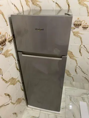 a grey refrigerator sitting on top of a counter at chez saad in Fès