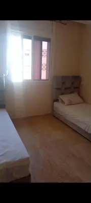 a bedroom with two beds and a window at Apartamento en Rabat al lado del Mar in Oulad Akkou