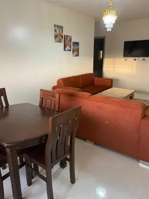 a living room with a couch and a table at Meknès cosy près Médina in Meknès