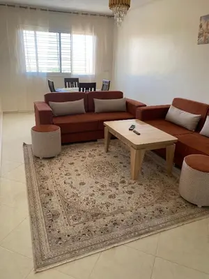 a living room with a couch and a coffee table at Meknès cosy près Médina in Meknès