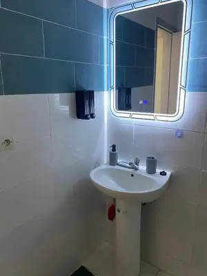 a bathroom with a sink and a mirror at Meknès cosy près Médina in Meknès
