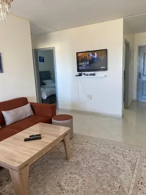 a living room with a couch and a coffee table at Meknès cosy près Médina in Meknès