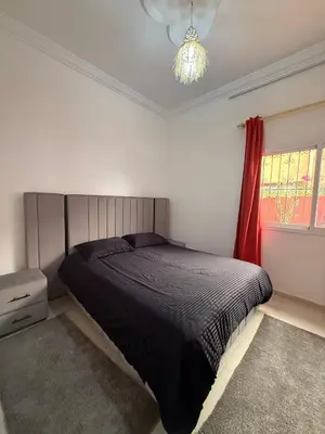 a bedroom with a black bed and a window at Dar Sofilal à Marrakech