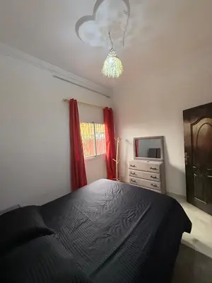 a bedroom with a black bed and a dresser at Dar Sofilal à Marrakech