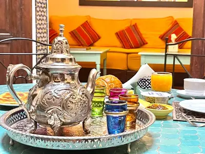 a silver tea pot on a tray on a table at Charming Riad Medina View 4 AC Bedrooms Panoramic Terrace Central Fez in Fès al Bali