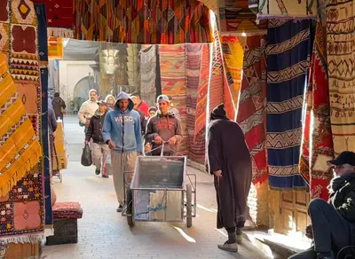 a group of people walking through a market at Charming Riad Medina View 4 AC Bedrooms Panoramic Terrace Central Fez in Fès al Bali