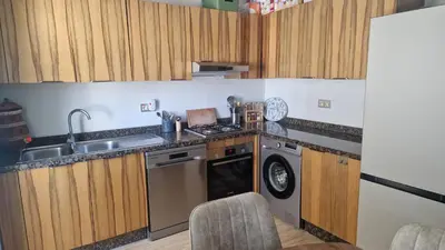 a kitchen with a sink and a dishwasher at Schöne Ferienwohnung mit Pools in Oulad Akkou
