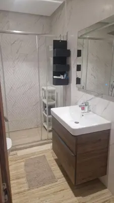 a bathroom with a sink and a shower at Schöne Ferienwohnung mit Pools in Oulad Akkou