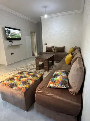 a living room with a couch and a tv at Appartement in Fès