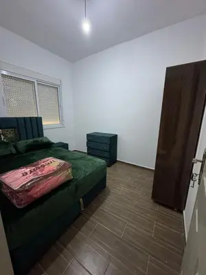 a living room with a green couch in a room at Appartement in Fès