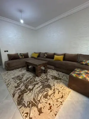 a living room with a couch and a coffee table at Appartement in Fès