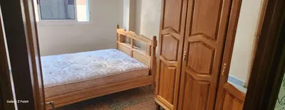 a small bedroom with a small bed next to a door at Dar imzouren al quods in Oulad Akkou