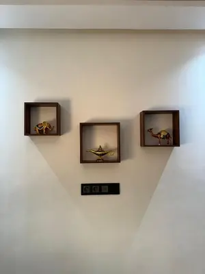 three pictures on a wall with a clock on it at Maison Privée avec Sauna Marrakech in Chouiter