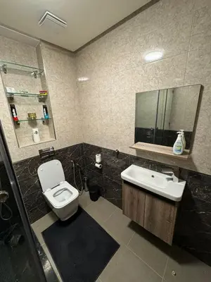 a bathroom with a toilet and a sink and a mirror at Maison Privée avec Sauna Marrakech in Chouiter