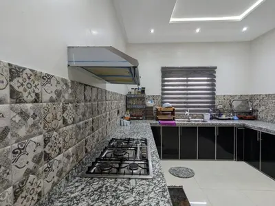 a kitchen with a stove and a counter top at Villa moulay abdella in Marrakech