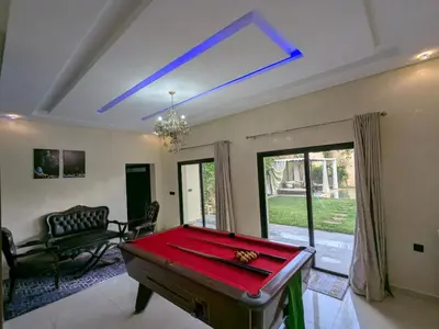 a living room with a pool table in it at Villa moulay abdella in Marrakech