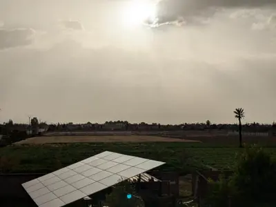 a solar panel in a field with the sun in the sky at Villa moulay abdella in Marrakech