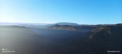 a view of a mountain range with fog in the foreground at Refuge AIT M'HAMED