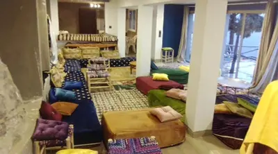 a living room with many couches and chairs at Refuge AIT M'HAMED