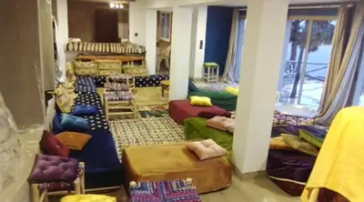 a living room with couches and chairs in a room at Refuge AIT M'HAMED