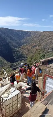 a group of people standing on top of a mountain at Refuge AIT M'HAMED