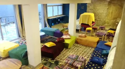 a room with many different colored pillows and chairs at Refuge AIT M'HAMED